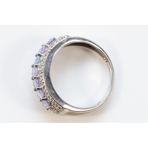 665 - A 9ct white gold diamond and tanzanite wide band ring, P, 3.4g