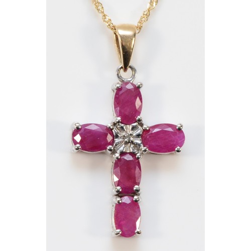 668 - A 9ct gold diamond and ruby cross pendant with chain, 23mm cross length, 3.5g