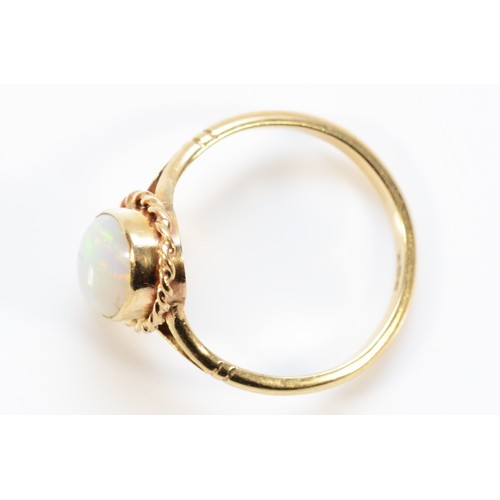 677 - A 9ct gold opal single stone ring with rope edging detail, 11mm x 7mm opal, S, 3.2g