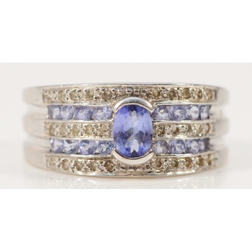 679 - A 9ct white gold tanzanite and diamond five row ring, P 1/2, 5g