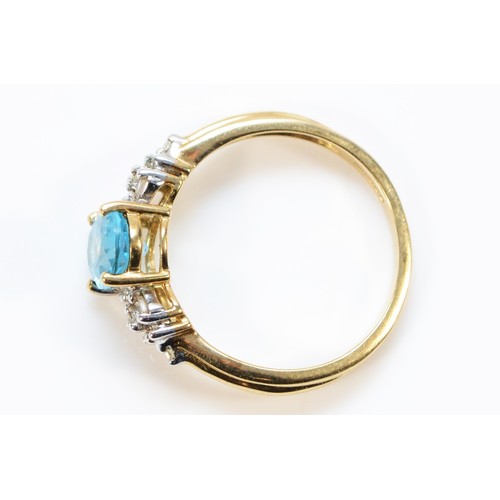 685 - A 9ct gold vari cut diamond and blue topaz dress ring, 7mm x 5mm topaz, N, 2.5g