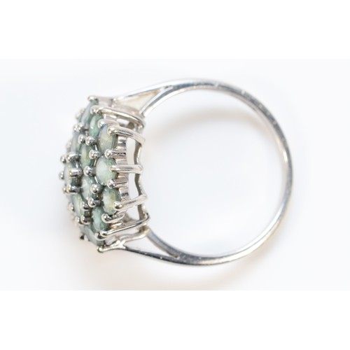 697 - A 9ct white gold green gemstone cluster ring, 15mm ring front, N, 3.3g