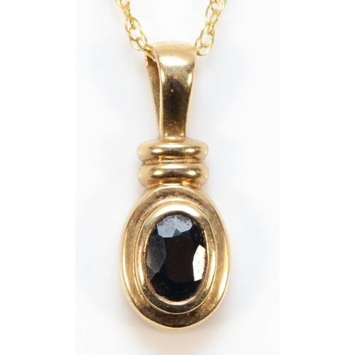 712 - A 9ct gold sapphire pendant with chain, 18mm total pendant length, 1.9g