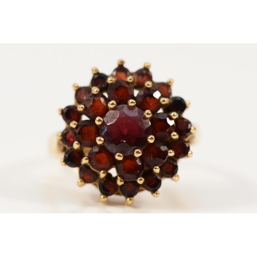 715 - A 9ct gold vintage garnet cluster ring, 14mm ring front, F, 2.8g