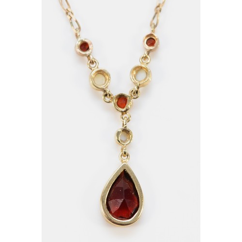 717 - A 9ct gold garnet and seed pearl necklace, 10mm x 6mm main garnet, 3g