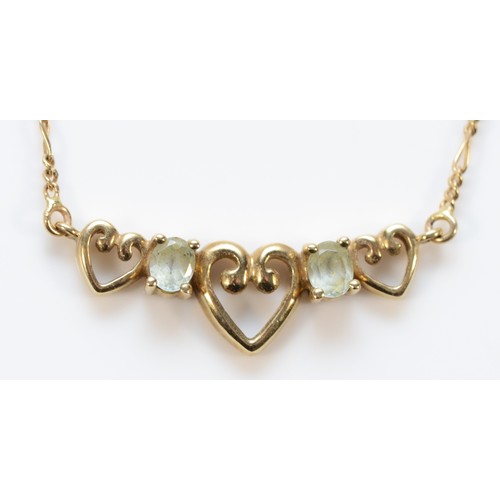 718 - A 9ct gold blue topaz heart patterned necklace, 25mm front, 3.2g