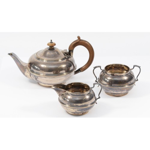 4 - A silver three piece bachelors tea service, London 1922, of compressed form, comprising tea pot, sug... 