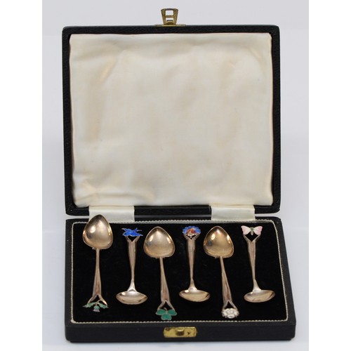 25 - A silver and enamel set of six coffee spoons, Birmingham 1938, the terminals with white rose, shamro... 