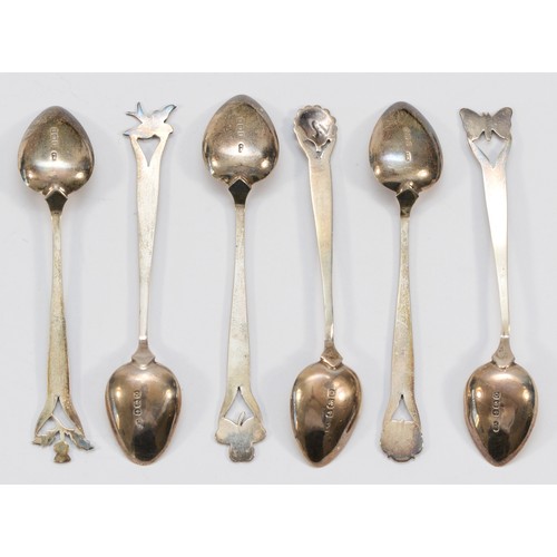 25 - A silver and enamel set of six coffee spoons, Birmingham 1938, the terminals with white rose, shamro... 