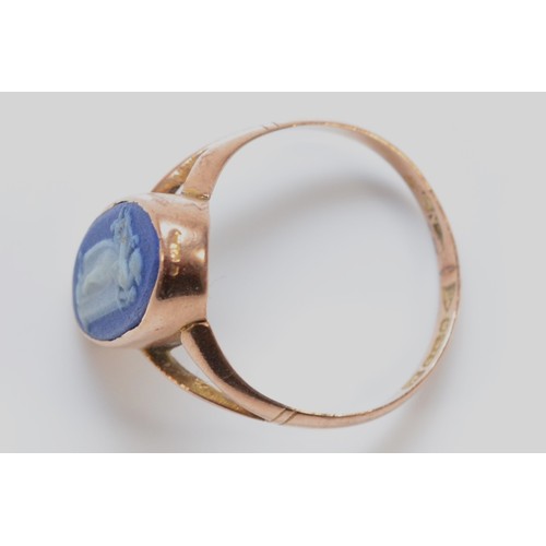 74 - A 9ct rose gold Wedgwood blue jasperware ring depicting a woman playing a harp, split shoulders, Che... 