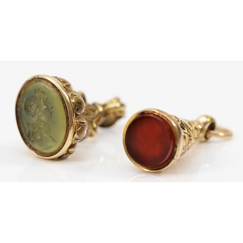 77 - Two unmarked 9ct gold Victorian fobs, one with a 7mm diameter carnelian base, the other with a hards... 