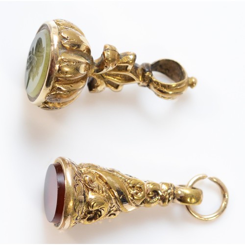 77 - Two unmarked 9ct gold Victorian fobs, one with a 7mm diameter carnelian base, the other with a hards... 