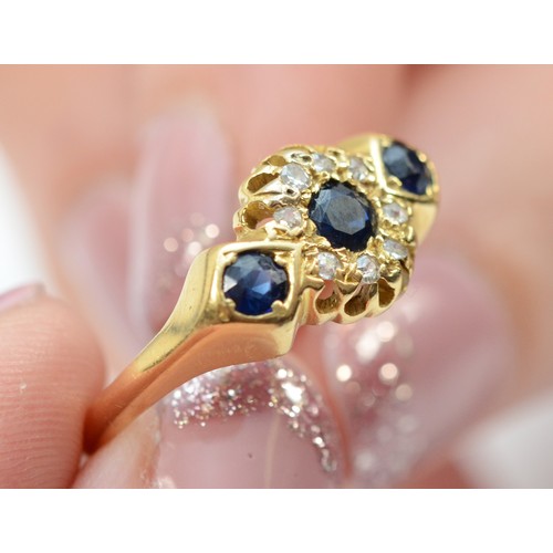 138 - An 18ct gold sapphire and diamond dress ring, three 3mm sapphires surrounded by old cut diamonds, Ch... 