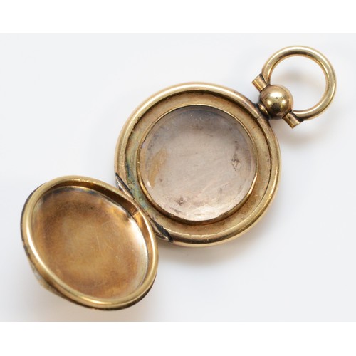 140 - A 9ct gold Victorian locket in the form of a pocket watch, glass in one side, 20mm diameter, 4.9g