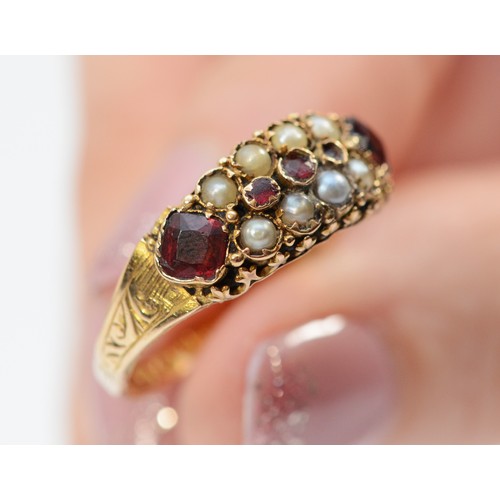 147 - A 15ct gold antique garnet and seed pearl dress ring, Birmingham 1878, engraved pattern around the w... 