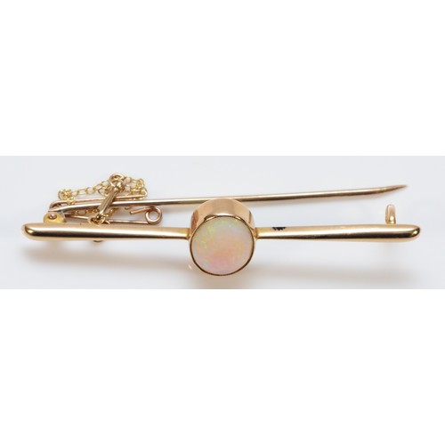 155 - An 18ct gold opal bar brooch, with safety chain, 14mm x 9mm opal, good colour play, 60mm across, 5g