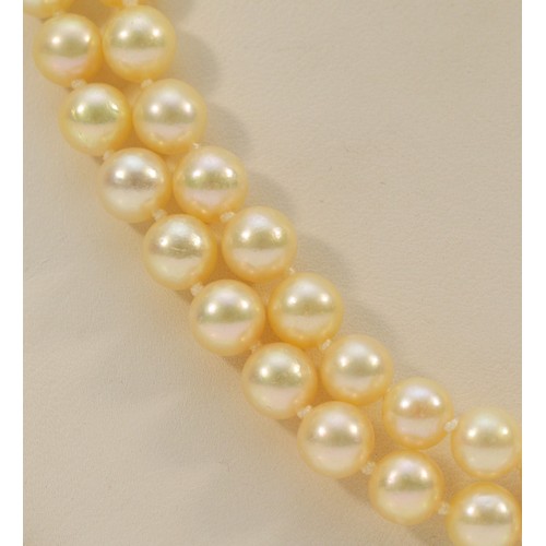 162 - A 9ct gold clasp cultured pearl necklace, floral clasp stamped with the maker JKa, double row of pea... 