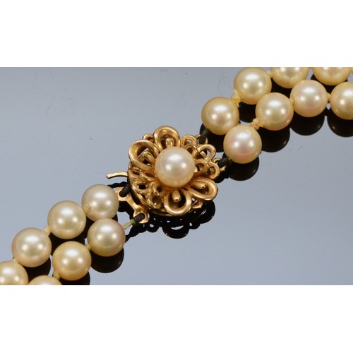 162 - A 9ct gold clasp cultured pearl necklace, floral clasp stamped with the maker JKa, double row of pea... 