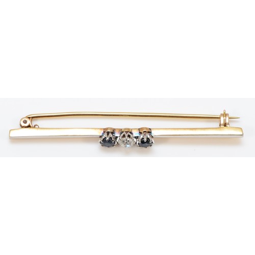 167 - An unmarked 15ct gold and platinum brilliant old cut diamond and sapphire three stone bar brooch, di... 