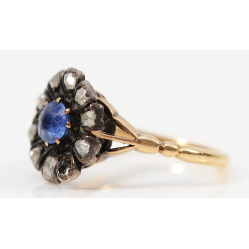 168 - An 18ct gold and silver old cut diamond and sapphire floral cluster ring, one diamond setting vacant... 