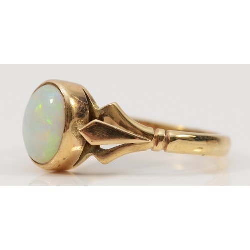 183 - A 9ct gold opal dress ring, London 1982, 9mm x 7mm opal, decorative split shoulders, V 1/2, 3.7g