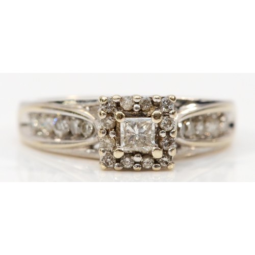 191 - Keepsake, a 14k white gold diamond dress ring, central Princess cut diamond surrounded by brilliant ... 