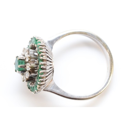 195 - An 18ct white gold brilliant cut diamond and emerald floral cluster ring, 15mm diameter cluster, L 1... 