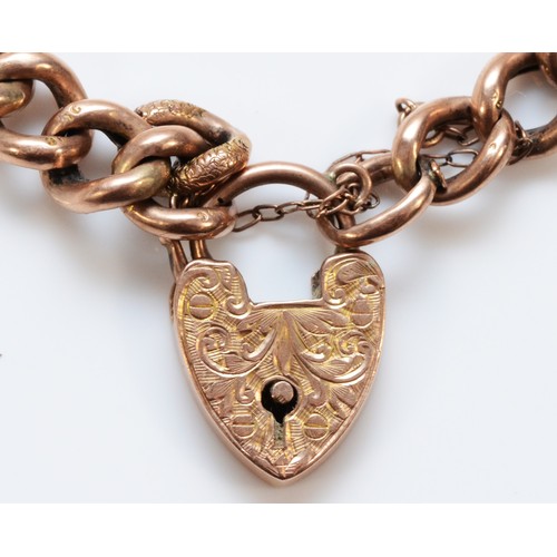 213 - An Edwardian 9ct rose gold Night and Day graduated hollow curb link bracelet, engraved heart padlock... 