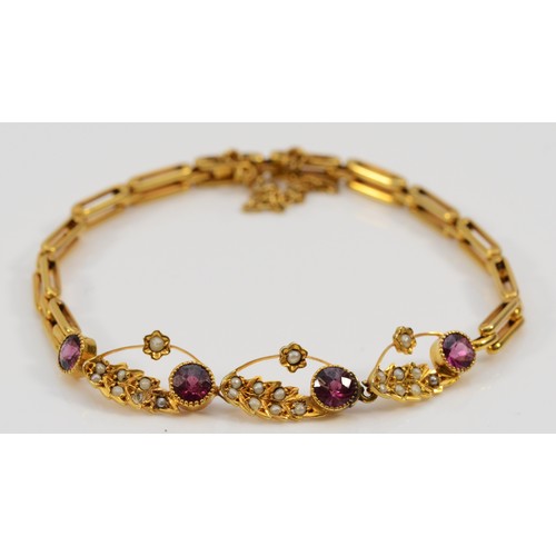 214 - An Edwardian unmarked 15ct gold, almandine garnet and half pearl bracelet, 16.5cm, 7.3gm.