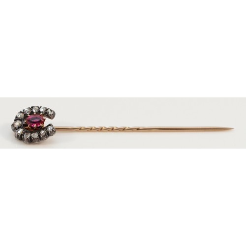 217 - A Victorian unmarked gold and silver set old cut diamond and ruby horseshoe stickpin, head 12 x 10mm... 