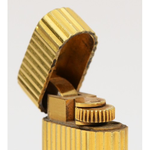 260 - Cartier, Paris, a gold plated oval rollagas ribbed lighter, signed, numbered 27200 S