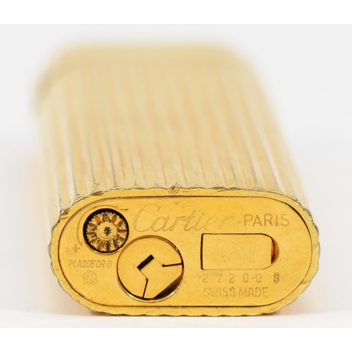 260 - Cartier, Paris, a gold plated oval rollagas ribbed lighter, signed, numbered 27200 S