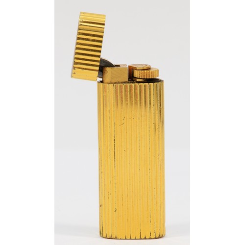 261 - Cartier, Paris, a gold plated oval rollagas ribbed lighter, signed, numbered E 19100, non Cartier po... 