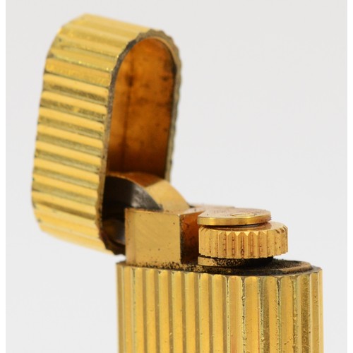 261 - Cartier, Paris, a gold plated oval rollagas ribbed lighter, signed, numbered E 19100, non Cartier po... 