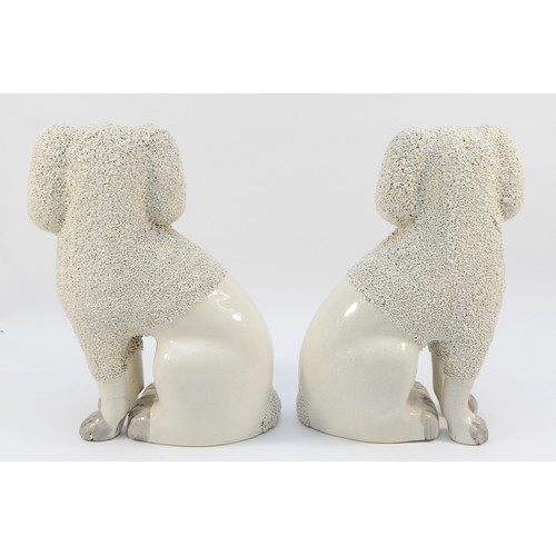 278 - A pair of late nineteenth century Staffordshire Pottery dogs, modelled as Poodles with textured or c... 