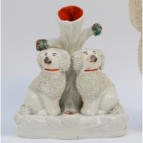 279 - A pair of late nineteenth century Staffordshire Pottery dogs, modelled as Poodles with textured or c... 