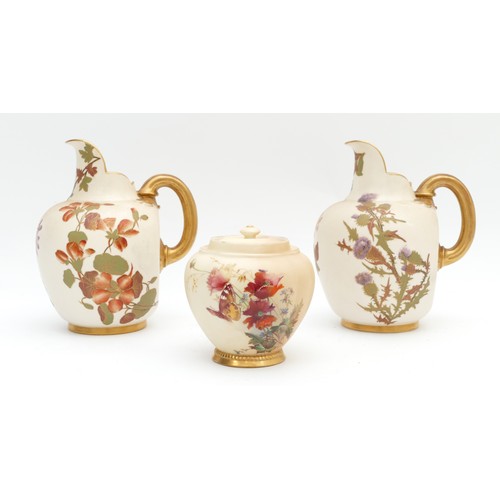 287 - A pair of Royal Worcester pitchers, together with a lidded jar, decorated in blush ivory with a flor... 