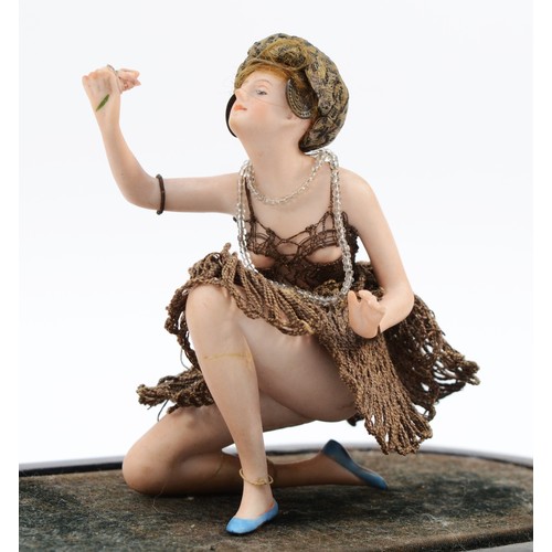 298 - Galluba and Hofmann, a German painted bisque figurine of a kneeling flapper lady holding a rose, c.1... 