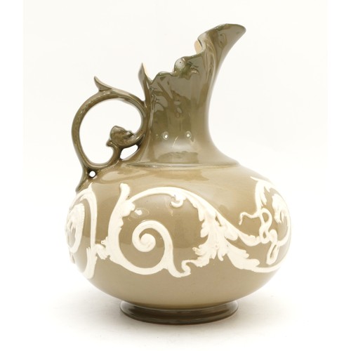 306 - An early twentieth century James Macintyre Washington Faience ewer, with scalloped spout and a raise... 