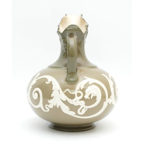 306 - An early twentieth century James Macintyre Washington Faience ewer, with scalloped spout and a raise... 