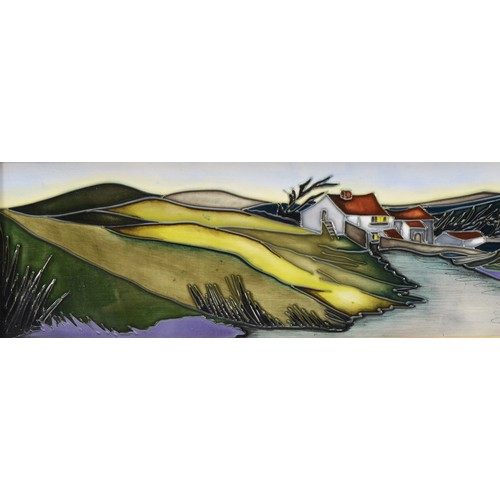 335 - A Moorcroft plaque, depicting house nestled amongst green hills, with a river in the foreground, des... 