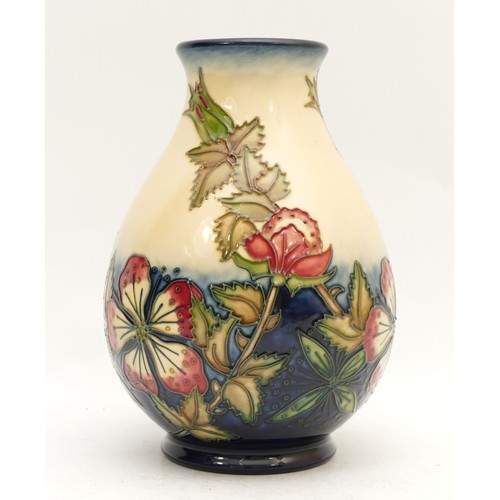 375 - A Moorcroft vase, depicting mauve florals, set against a cream and navy backdrop, in a pattern remin... 