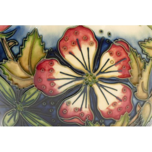 375 - A Moorcroft vase, depicting mauve florals, set against a cream and navy backdrop, in a pattern remin... 