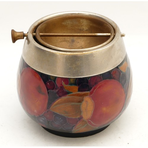 392 - A Moorcroft ashtray, in the pattern, 'Pomegranate', with a pewter rim, manufactured between 1928 and... 