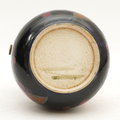 392 - A Moorcroft ashtray, in the pattern, 'Pomegranate', with a pewter rim, manufactured between 1928 and... 