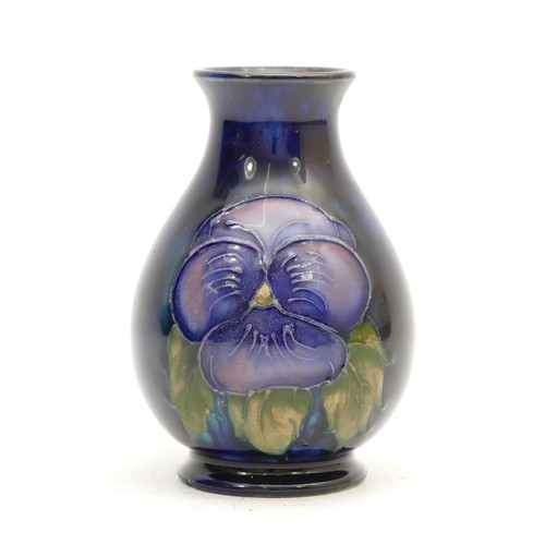 396 - A Moorcroft vase, in the pattern, 'Pansy', on cobalt blue ground, manufactured between 1928 and 1949... 