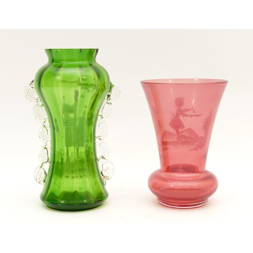 407 - Two Mary Gregory glass vases, hand-decorated with white enamel, in green glass and cranberry glass.