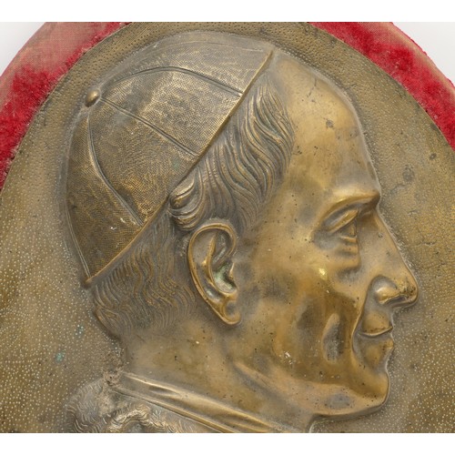 430 - A gilt bronze plaque, depicting the Pope, possibly Pope Pius XII, on a red velvet oval mount, 49cm x... 