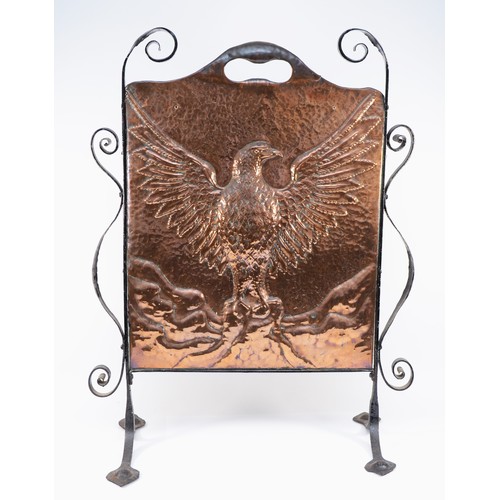 445 - An Arts and Crafts hand beaten copper fire screen, c. 1910/20, depicting an eagle with outstretched ... 