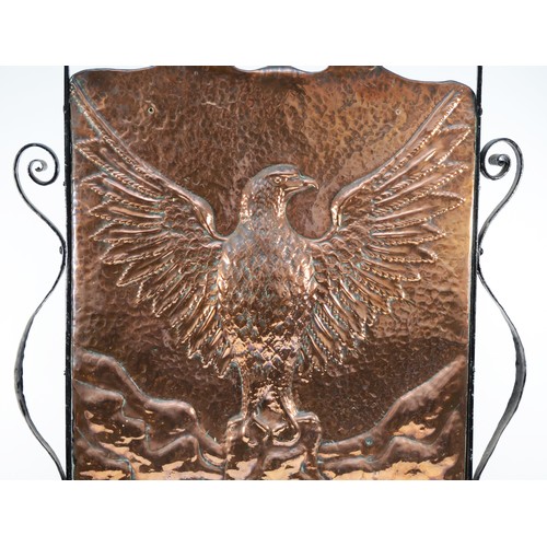 445 - An Arts and Crafts hand beaten copper fire screen, c. 1910/20, depicting an eagle with outstretched ... 